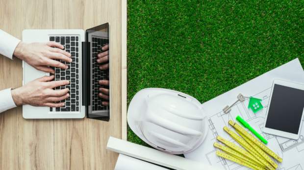Engineer,Designing,A,Green,Sustainable,House,And,Using,A,Laptop,