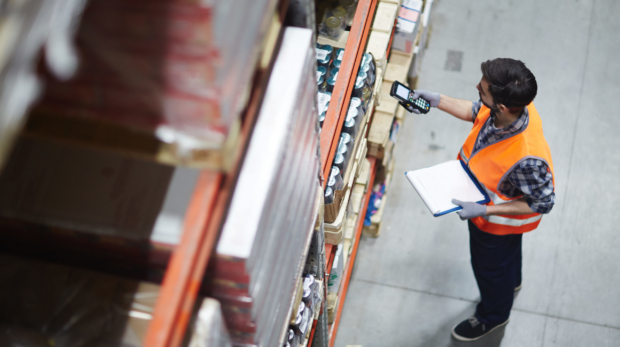 Worker,With,Scanner,Making,Review,Of,Goods,In,Warehouse